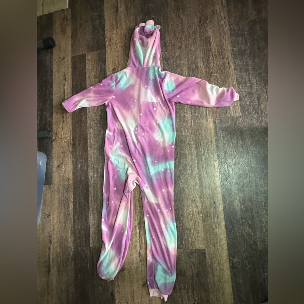 This is a unicorn pajama jumpsuit that is purple, pink, blue and white. Size 6.